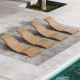 Four teak wood patio folding chaise lounge chairs with slatted seats, perfect for poolside relaxation and outdoor.