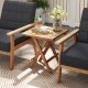 Teak wood square coffee table with slatted top and X-shaped legs, perfect for outdoor use and easy storage.