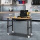 Adjustable height mobile workbench with natural bamboo top, lockable wheels, and heavy-duty metal frame for versatile.