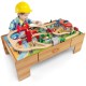 Wooden train set table with 100 pieces, featuring a reversible design and storage drawer for imaginative play.