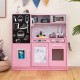 Pink toddler pretend play kitchen featuring a removable sink, stove with cookware, and built-in blackboard for.