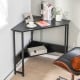 Triangle computer corner desk in black with charging station, featuring a spacious design for small living spaces.