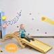Wooden arch climber with ramp and blue mat, perfect for kids' play and development, promoting balance and imagination.