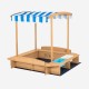 Kids wooden sandbox with striped canopy, solid cedar wood, includes seating and plastic bins for sand and water play.