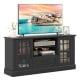 Black TV stand for TVs up to 70 inches featuring glass doors, adjustable shelves, and a large drawer for versatile.