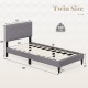 Twin size bed frame with upholstered headboard, geometric quilting, and sturdy slats for modern bedroom decor.