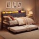 Pull-out trundle bed beneath the Twin Size Daybed in rustic brown, offering extra sleeping space for guests and.