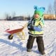 Kids metal wheelbarrow in red with seamless steel tray, perfect for outdoor play and transporting toys in the snow.