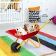Red metal wheelbarrow for kids filled with plush toys, perfect for yard play and transporting treasures.