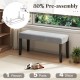 Gray end of bed bench with padded velvet seat and solid wood legs, ideal for bedroom or entryway storage.