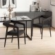 Set of 2 black upholstered armchairs with ergonomic backrest and padded seat, perfect for dining or relaxing.