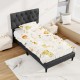 Gray twin size upholstered platform bed with tufted headboard, featuring a playful animal print bedding set for.