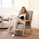 Upholstered rocking chair in gray with rubber wood frame, perfect for reading or relaxing in any room.