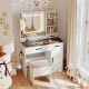 Vanity desk with lighted mirror, ample storage, and a stool, designed in a farmhouse style for makeup application.