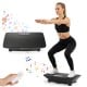 Vibration plate exercise machine in black with remote control, featuring a rubber surface and gravity sensor for home.