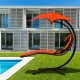 Orange hanging chaise lounger swing chair with adjustable canopy and ergonomic design, perfect for stylish backyard.
