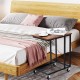 Mobile side table with a brown wood top and metal frame, ideal for bedside or sofa use, featuring rolling casters.