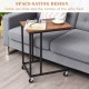Mobile side table with brown wood top and metal frame, designed to slide under sofa or bed for versatile use.