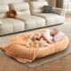 Cozy washable fluffy human dog bed in brown with soft blanket and plump pillow, perfect for pet interaction and.