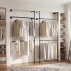 Wall mounted black clothing rack with two hanging rods, designed for organized storage in closets or retail displays.