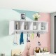 Wall-mounted storage cabinet in white with four compartments and five hooks, ideal for organizing entryway essentials.