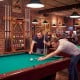 Close-up view of the wall-mounted billiards pool cue rack in brown, highlighting the clips for 8 cues and stylish.