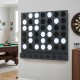 Wall-mounted Jumbo 4-in-a-Row game features black acrylic discs, perfect for garages, basements, and game rooms.