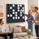 Wall-mounted Jumbo 4-in-a-Row game in black features sleek acrylic discs, perfect for family fun in game rooms.