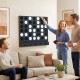 Wall-mounted black Connect-4 game with acrylic discs, perfect for garages and game rooms, providing fun for all ages.