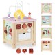 Wooden activity cube for toddlers featuring a dessert theme and removable blocks, designed to enhance sensory and motor.