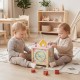 Wooden activity cube with sensory toys, featuring shape matching blocks and a pretend kitchen, perfect for toddlers.