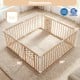 Large wooden baby playpen with adjustable size, natural pine construction, and interactive toys for safe playtime.