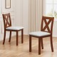 Two wooden dining chairs with padded beige seats and X-shaped backs, crafted from durable acacia wood for stylish.