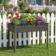 Wooden raised vegetable garden bed in gray with colorful flowers, ideal for patio or backyard planting.