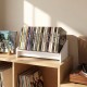 Small white wooden tilting bookshelf organizer displaying vinyl records, ideal for tidy desktop storage and easy access.
