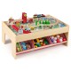 Wooden train set table with reversible tabletops, 94 accessories, and storage drawers for kids' imaginative play.