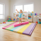 Colorful gymnastics mat with a folding balance beam, designed for kids' balance training and safe practice at home.
